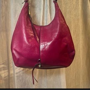 An iconic Hobo silhouette. Merlot in color is crafted in vintage hide.